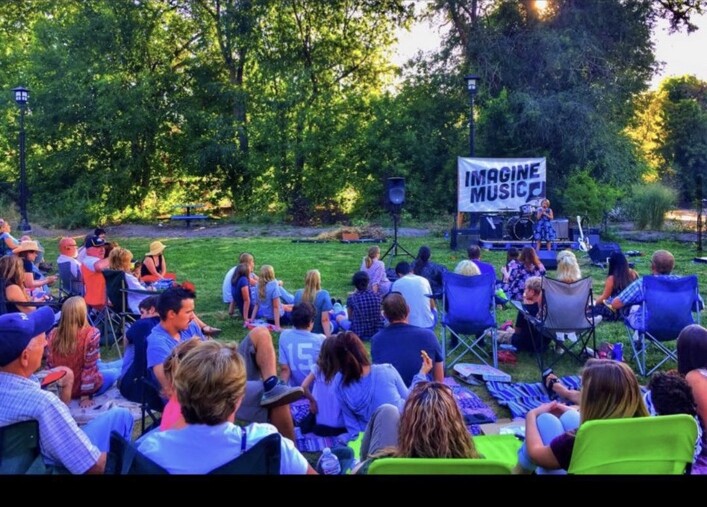 Families gathered for an early Imagine Music outdoor performance in Ogden