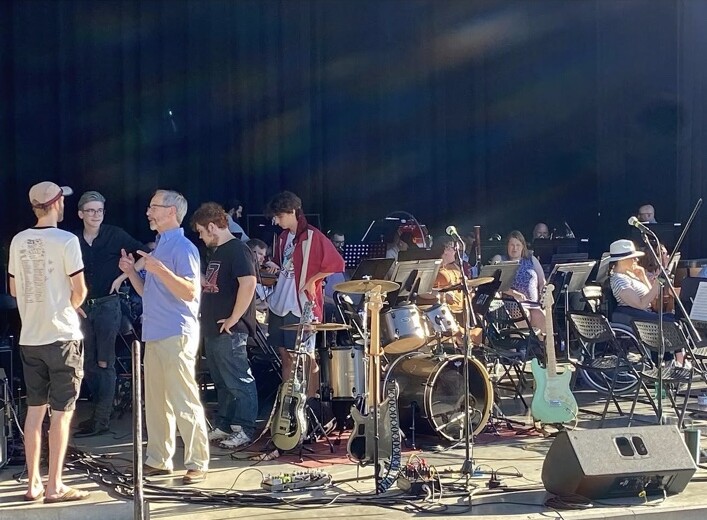 Imagine Music students sharing the Ogden Amphitheater stage with orchestral musicians