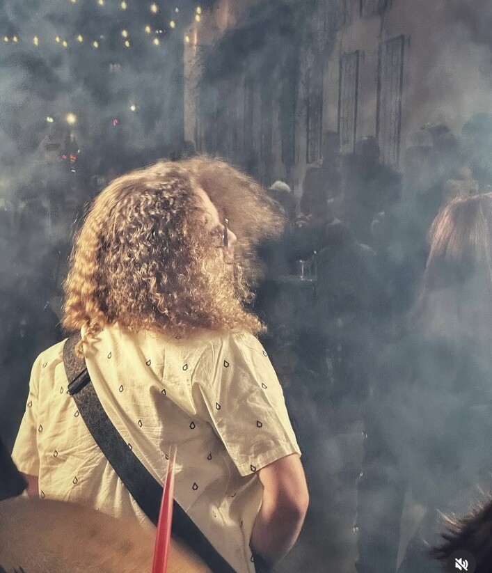 A student musician performing under stage lights